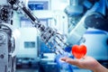 Human heart on hand send to a robot for make the robots have feelings, love, like a human. Royalty Free Stock Photo