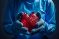 A human heart held by medical hands for illustration