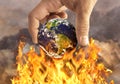 Human holding earth on fire Royalty Free Stock Photo