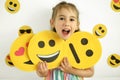 Human holds emoticons with different emotions in her hands: a sad, smiling happy smile, a loving smile with hearts instead of eyes Royalty Free Stock Photo