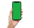 Human left hand holding black mobile smartphone with green screen