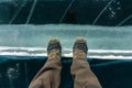 Human legs in hiking boot in ice crampons on the texture Baikal ice Royalty Free Stock Photo