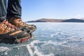 Human legs in hiking boot in ice crampons on the texture Baikal Royalty Free Stock Photo