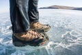 Human legs in hiking boot in ice crampons on the texture Baikal Royalty Free Stock Photo