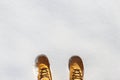 Human legs with leather yellow boots standing in the snow. Top v Royalty Free Stock Photo
