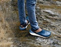 Human legs safely standing on a wet rock surface. Royalty Free Stock Photo