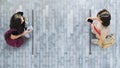 Human life in Social distance. Aerial top view with two student women with smartphone stand at grey pavement street road with