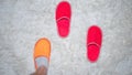 Foot in slippers,slippers on a white rug on the floor,a sign of loneliness.