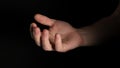 Human male palm clench a fist isolated on black background. Close up.