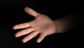 Human male palm clench a fist isolated on black background. Close up.