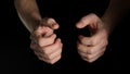 Human male palm clench a fist isolated on black background. Close up.