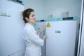 Human Milk Bank laboratory. Lab assistant opening freezer where containers with breast milk stored