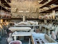 Human mummy and earthenware jugs in ancient Pompeii