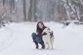 Human and Pet Relationships Concepts. Portrait of Lovely Caucasian Brunette Woman Along With Her Husky Dog