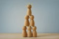 Human pyramid made of wooden pawn - Concept of teamwork and success Royalty Free Stock Photo