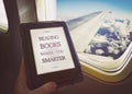 Human reading book inside airplane Royalty Free Stock Photo
