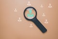 Human Resource Management, Magnifier glass focus to manager icon which is among staff icons for human development recruitment lead Royalty Free Stock Photo