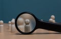 Human Resource Management, Magnifier glass focus to manager icon which is among staff icons for human development recruitment lead Royalty Free Stock Photo