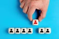 Human resources and employment concept with male hand arranging wooden blocks with manager and staff icons Royalty Free Stock Photo