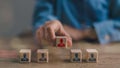 Human resources and employment concept with male hand arranging wooden blocks with manager and staff icons Royalty Free Stock Photo