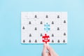 Human resources management and recruitment business build team concept. Image of tangram puzzle blocks with people icons over Royalty Free Stock Photo