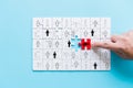 Human resources management and recruitment business build team concept. Image of tangram puzzle blocks with people icons over Royalty Free Stock Photo