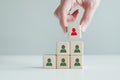 Recruiter complete team by one leader person, professional staff research, hand hold red people icon on cube. Royalty Free Stock Photo