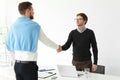 Human resources manager shaking hands with applicant during job interview Royalty Free Stock Photo