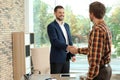 Human resources manager shaking hands with applicant during job interview Royalty Free Stock Photo