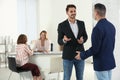 Human resources manager speaking with applicant before job interview Royalty Free Stock Photo