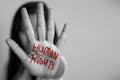 Human rights concept. woman raised her hand for dissuade, hand write the word human rights in red color Royalty Free Stock Photo