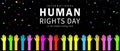 Human Rights Day. International peace. Various colored hand icons raising their hands with colorful ribbon confetti on black. Royalty Free Stock Photo