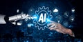 Human and Robot Hands Interacting with AI Technology Symbols and Digital Elements Representing Future Innovations and Royalty Free Stock Photo
