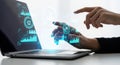Human and robot hands interacting with futuristic digital interface on laptop screen Royalty Free Stock Photo