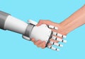Human and robot handshake with empty space on blue background, artificial intelligence, AI, in futuristic digital technology and Royalty Free Stock Photo