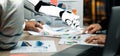 Collaboration between Human and Robot in Data Analysis, Showcasing Charts and Graphs to Enhance Business Decision-Making Royalty Free Stock Photo