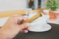 human`s hand holding brown and white sugar sachets with blurred ceramic coffee cup in restaurant Royalty Free Stock Photo
