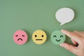 Human`s hand holding happy smile face paper cut with speech bubble on , satisfaction survey ,good feedback