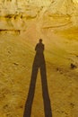 Human shadow on yellow sand Royalty Free Stock Photo