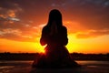 human silhouette praying against sunset Royalty Free Stock Photo