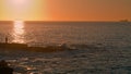 Human silhouette watching sunrise at ocean. Ferry sailing dawn tranquil water