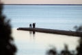 Human silhouettes on the beach at sunset. Nida Lithuania