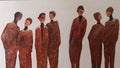 Human silhouettes in brown on the wall