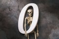 Human skeleton and number zero on a dark background, top view. Zeroing concept Royalty Free Stock Photo