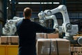 human supervisor overseeing robots palletizing task