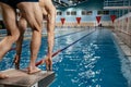 human swimmer, a young athletic athlete swims in a free style on the azure blue water in the pool. bottom view Royalty Free Stock Photo