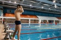 human swimmer, a young athletic athlete swims in a free style on the azure blue water in the pool. dbl c side Royalty Free Stock Photo