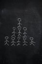 Human team pyramid on black chalkboard Royalty Free Stock Photo