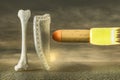 Human thigh bone protecting by shield from a giant bullet on asphalt in sunset cloudy day. Strong bones and healthy human bone or