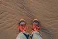 Human in trekking boots on a wet sand Royalty Free Stock Photo
